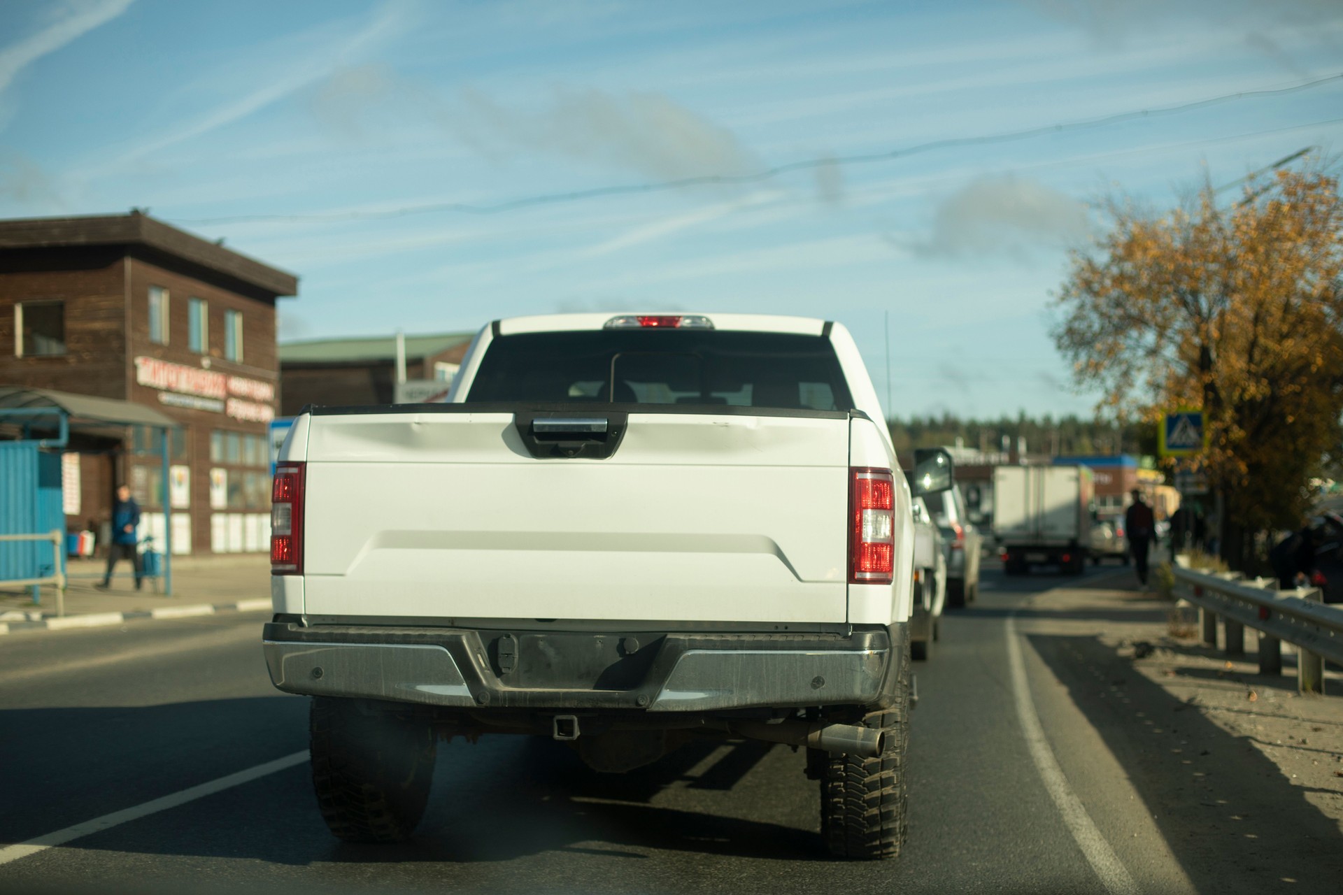 White pickup truck rides down road. Truck on road. Car body.